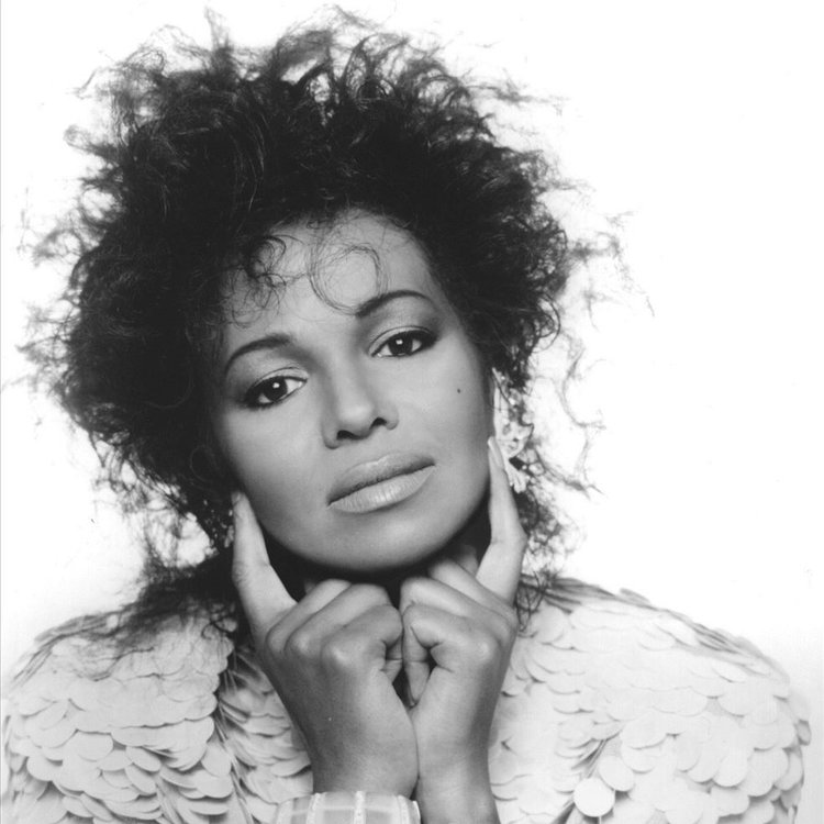 Maureen Reillette "Rebbie" Jackson-Brown posing for a photograph with her both hand's index finger on her cheek